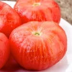 peeled tomatoes on a plate pic